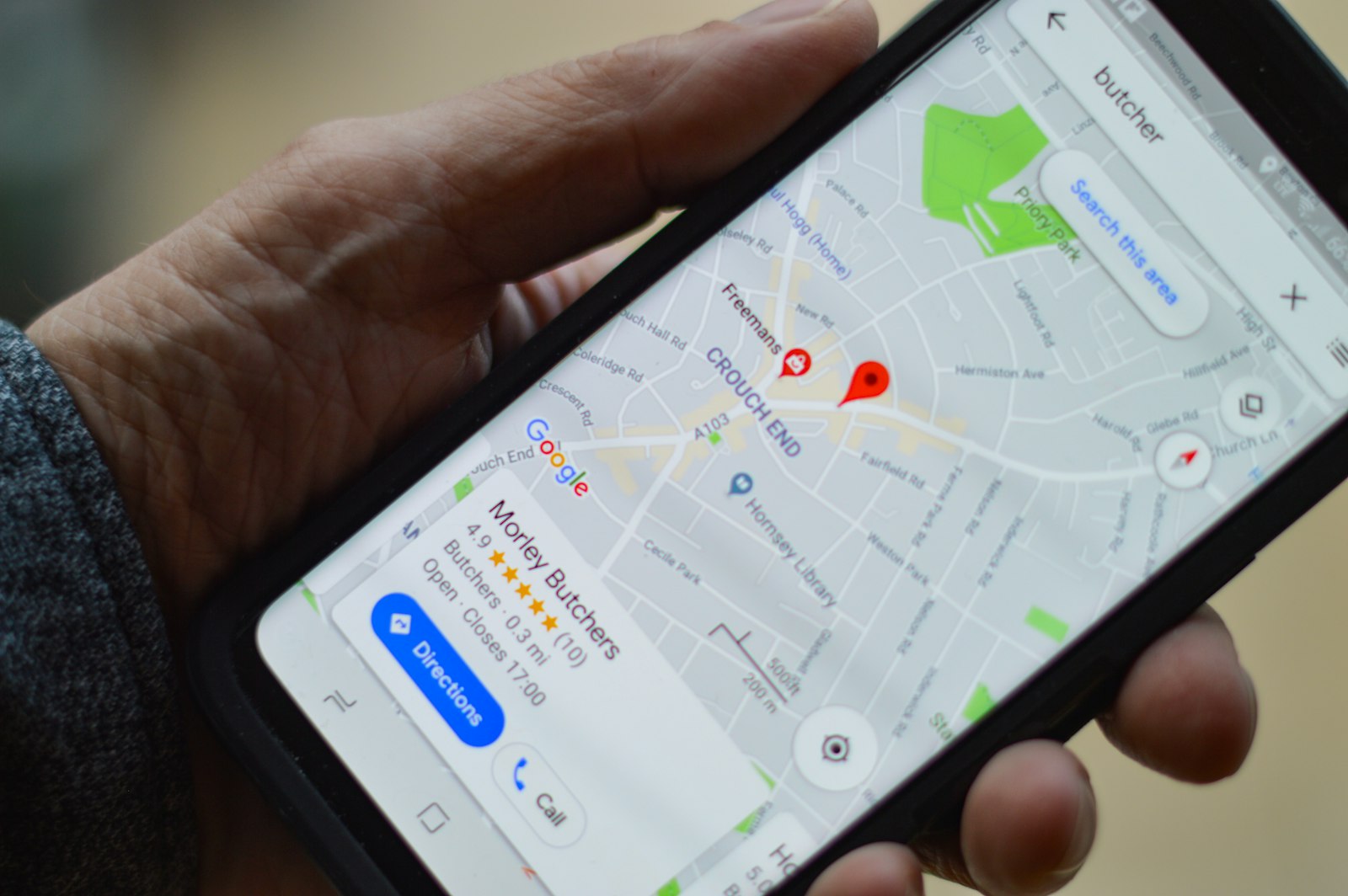 Hand holding a smartphone displaying a local map